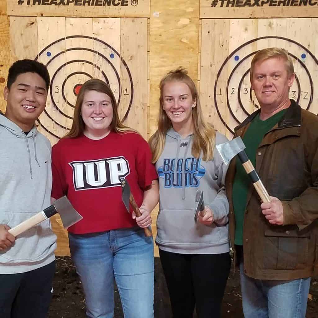 IUP students at an indoor axe throwing event