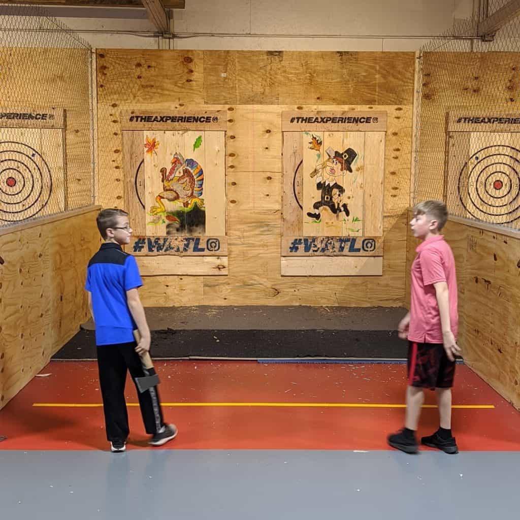 young axe throwers at an indoor lane