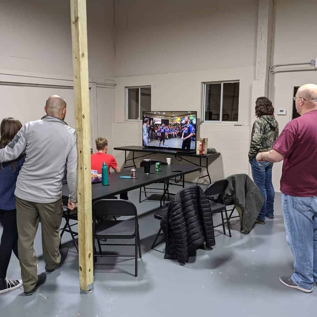 family watching a WATL event on a TV screen